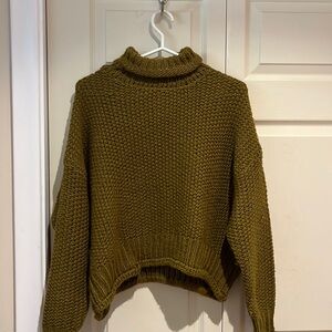 Woman’s green turtleneck. Breathable fabric and very warm.